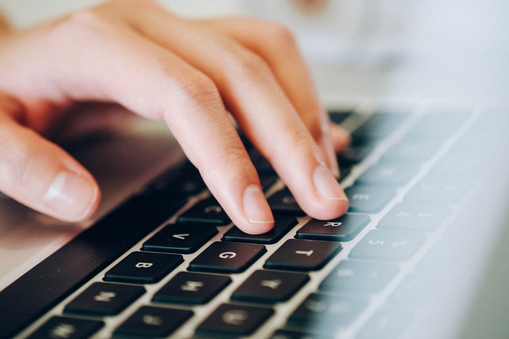 laptop human hands keyboard typing